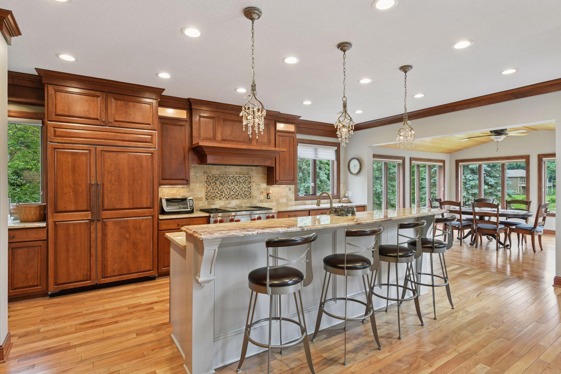 17558 George Moran Drive - Freshly painted sunroom and kitchen center island. New flooring. Kitchen has beautiful woodwork.