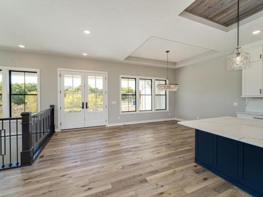 Double, glass-paned doors greet you at the front entrance.....also wood floors grace most all of the main level which keeps all rooms "feeling" larger to the eye.