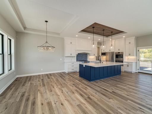 You can see to the upper right of this photo where the patio doors lead out to the covered, screened porch featuring wood ceilings, maintenance free decking and aluminum railings.