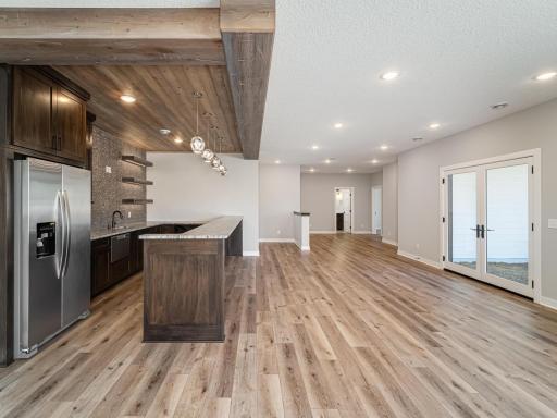 Walk into the bar and you'll find the full size refrigerator/freezer, undermount sink, plenty of cabinet space and more floating shelving. Wood paneled ceiling, pendant lighting and room for 6-8 bar stools make it an awesome place to entertain!