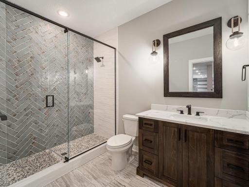 The lower level 3/4 bath is quite appealing....ceramic floors and walls. So cool!