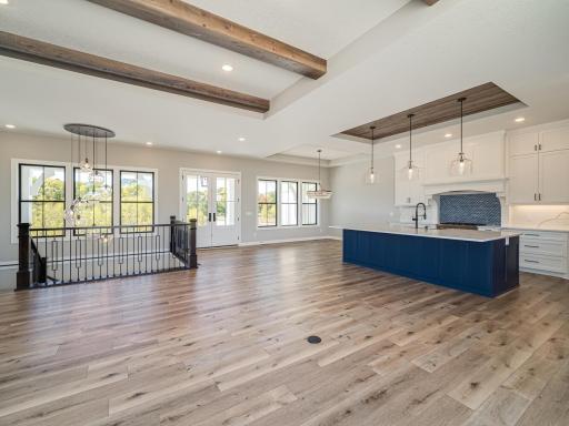 The inset/raised ceilings are over the kitchen, informal dining table area and the living room. Over the living room itself there are wood beams that span that area. You'll see almost wall to wall windows so natural light brightens up the main level.