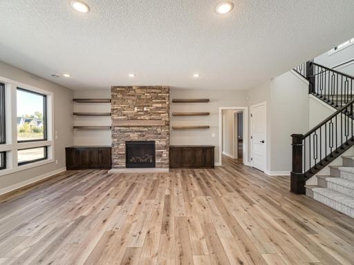 Behind the fireplace wall is the storage/mechanical room on the right, the 3/4 bath AND dog-wash area which leads to the outside and a big gym with glass/mirrored walls, rubber floor.