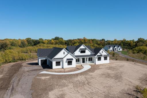 This side load garage would be nearest County Rd 10 and thus serve as a superb sound block/barrier to any traffic. Add in some berming and pine trees along the county road and you might forget it is even there.