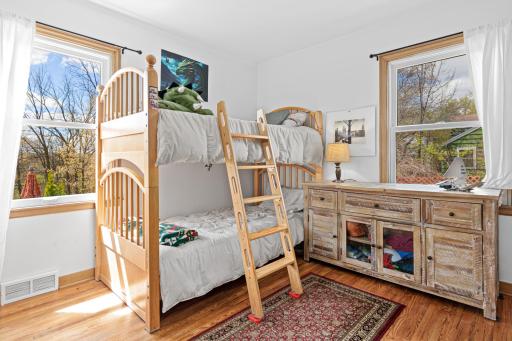 The second bedroom on the main level has views of the private backyard