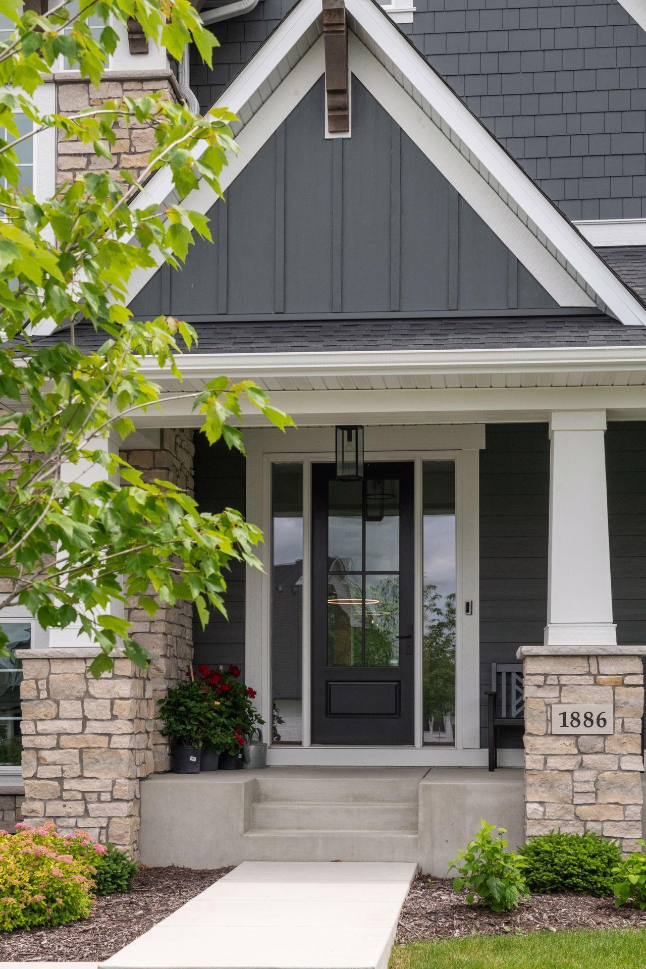 Impressive front porch complemented by exterior stonework