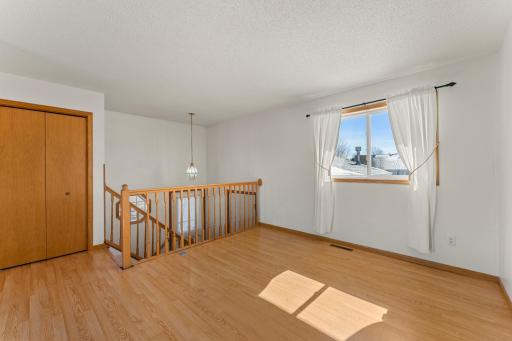 Spindle railing offers great views to the front door from your living room