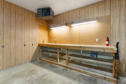 Garage has a workbench as well as a service door to the backyard.