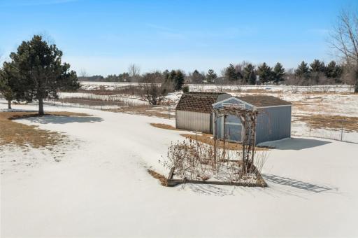 Backyard has 2 storage sheds and a garden area.