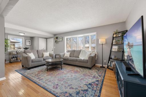 Large bay window floods the room with natural light