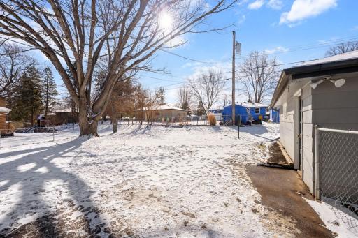 Large, fully fenced yard and mature trees.