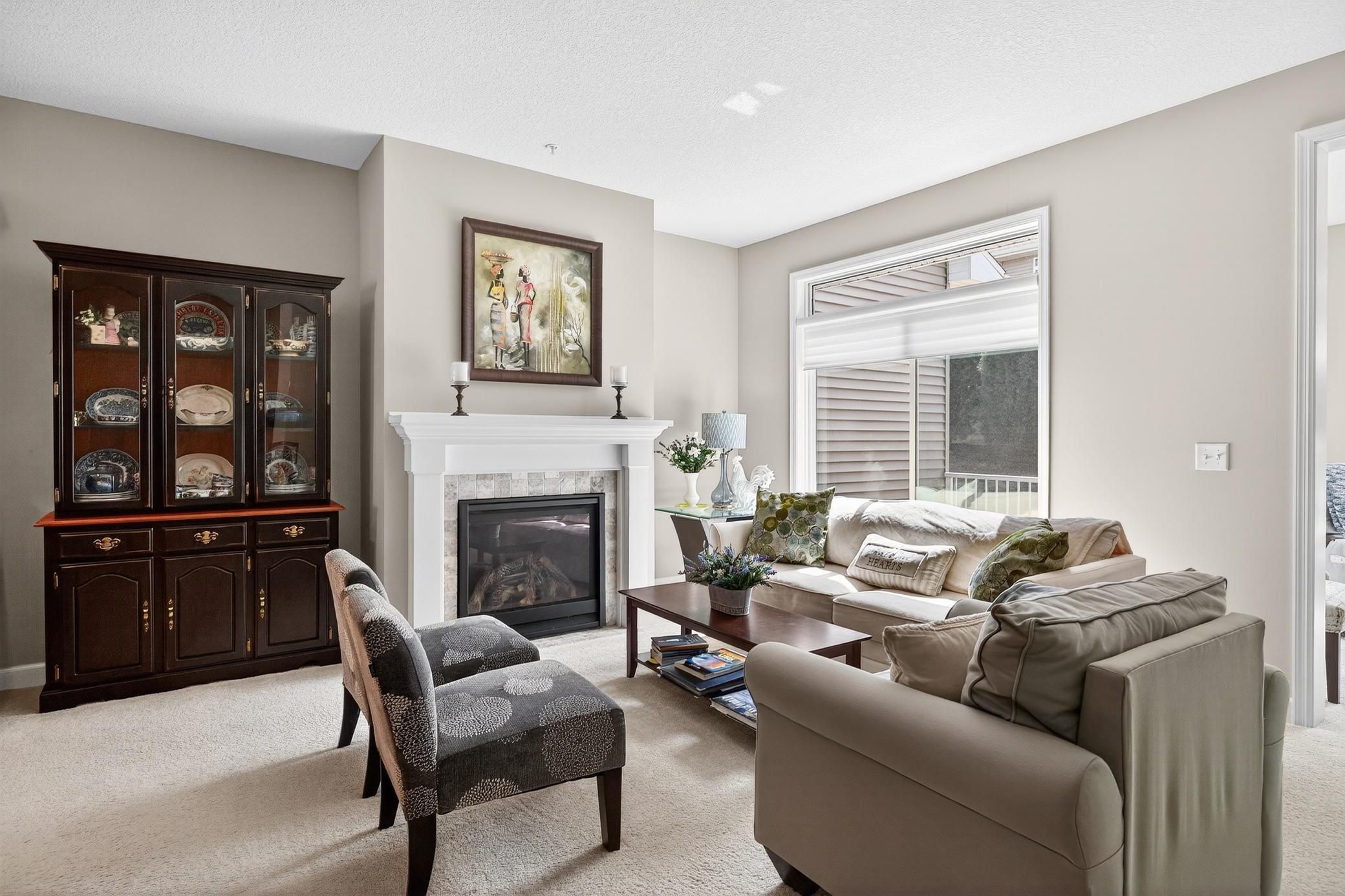 Beautiful sun-lit living room with gas fireplace...