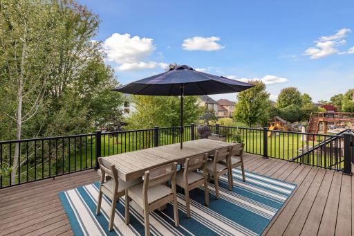 The deck features a maintenance-free railing and has a gate at the top of the stairs that lead to the backyard.