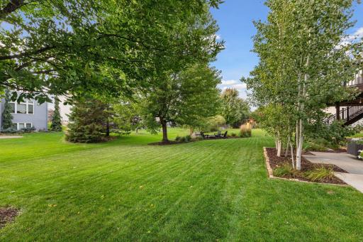 Enjoy the large, flat backyard, framed by mature trees and beautifully designed perennial landscaping that surrounds the home.