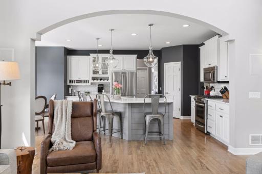 Beautiful hardwood floors run throughout the main level, while the kitchen opens to the family room and informal dining area for a seamless layout.