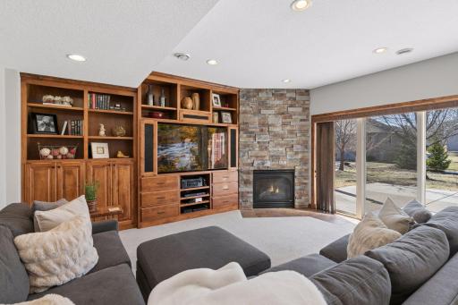 The lower level features a second gorgeous gas fireplace, beautiful woodwork, and opens to the oversized patio.