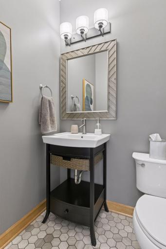 Main floor powder room features tile floors.