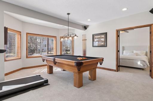 French doors lead to the fifth bedroom in the lower level.