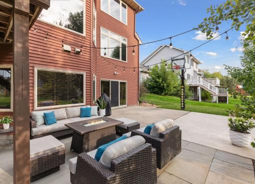 The back patio also includes an in-ground basketball hoop for outdoor recreation.