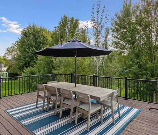The oversized deck is ideal for evening grilling and relaxing, framed by beautiful mature trees for added privacy.