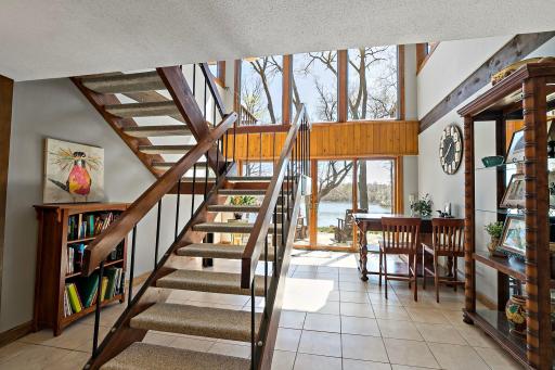 Enter the lower level onto tiled floor and a wall of windows! A great game room area.