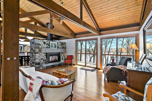 Enjoy this light filled living room with breath taking views of the lake! The architecture of this lake home is beyond amazing with vaulted and beamed ceilings on the entire main level.