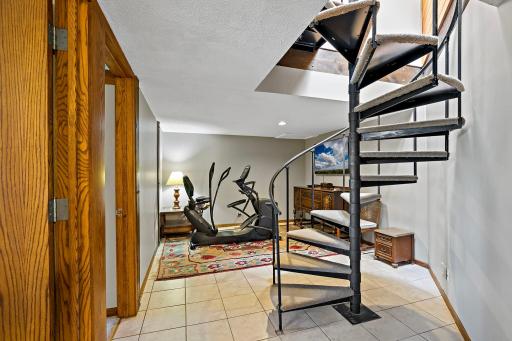 Second stairway to lower level enters into a space that can be used as an exercise area.