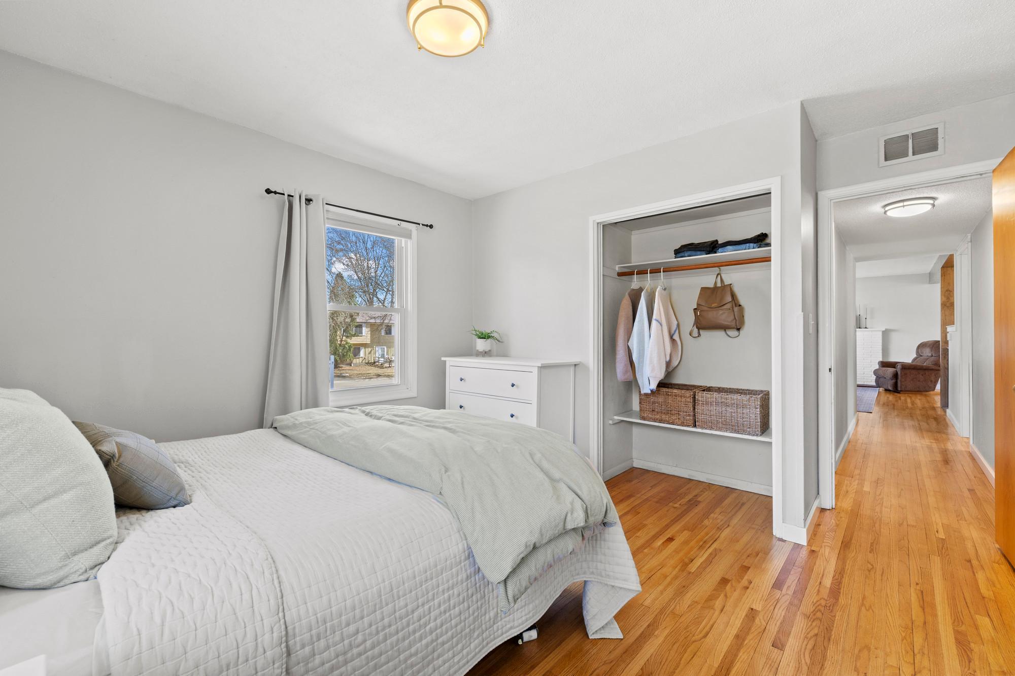 Spacious primary bedroom - notice the refinished hardwood floors throughout the main level