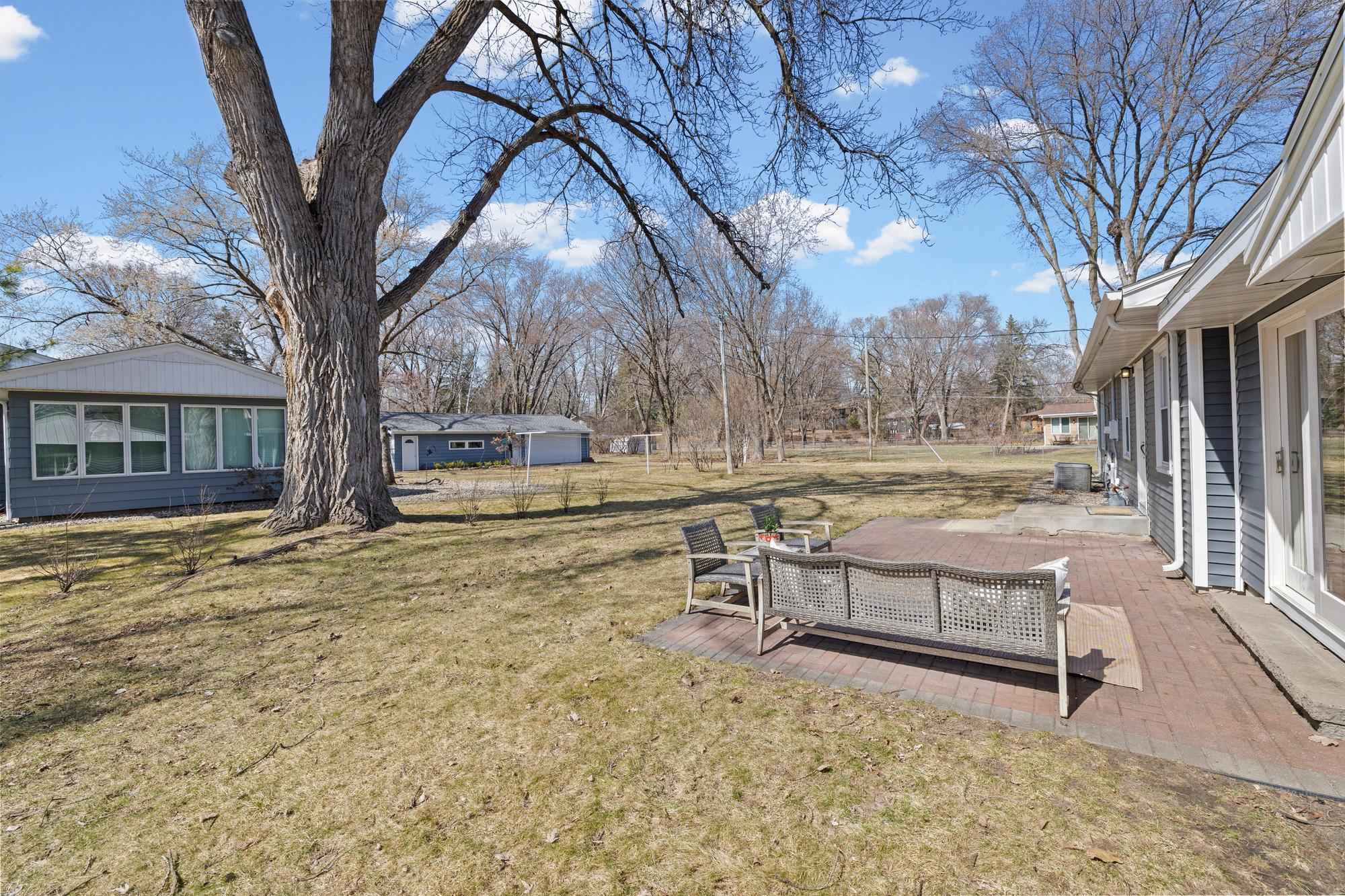 Spacious FLAT yard with Patio for entertaining. Walk right out from the kitchen to grill, or pass straight through the breezeway to the backyard through the new glass sliding door