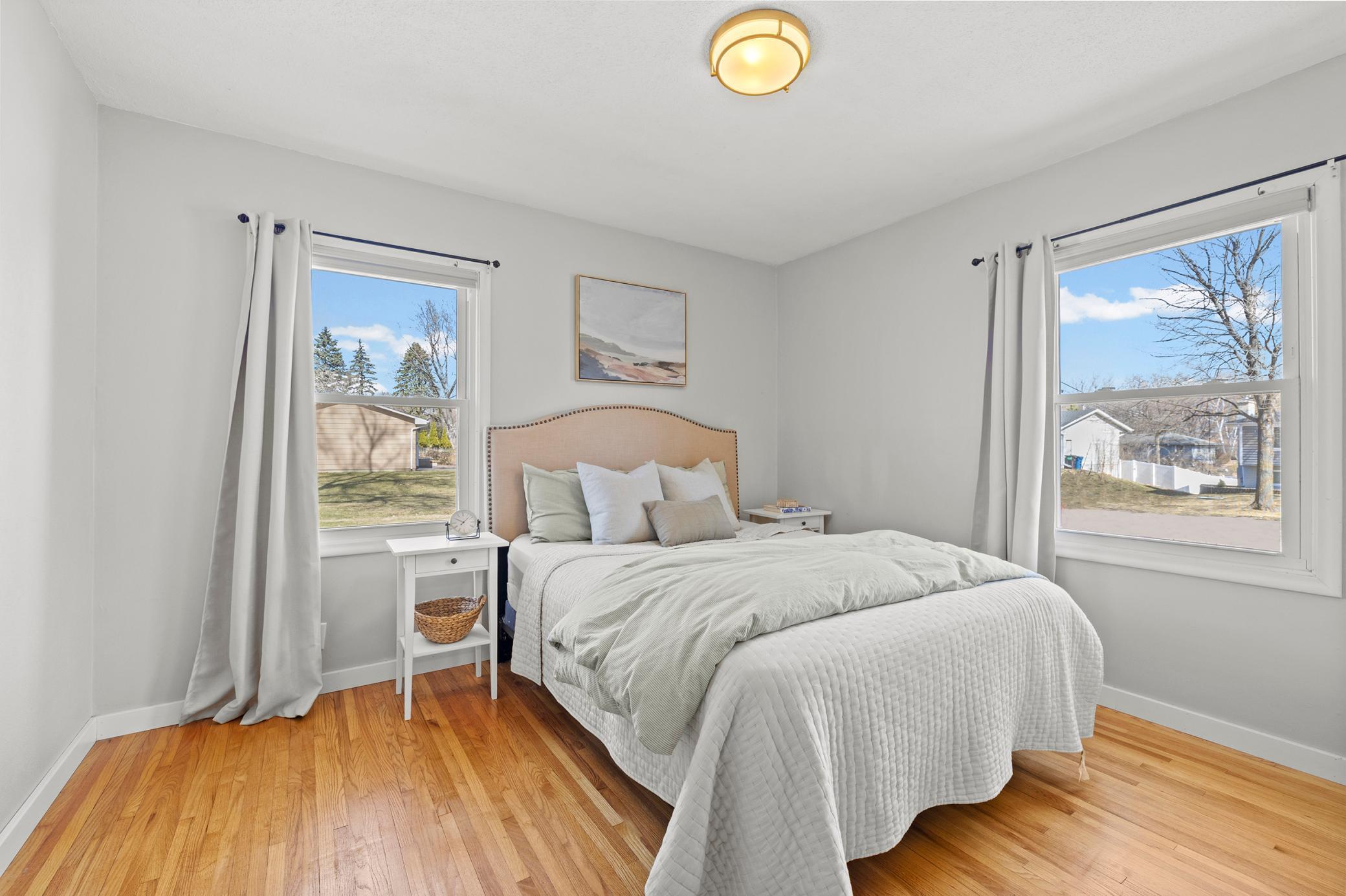 Spacious primary bedroom - notice the refinished hardwood floors throughout the main level