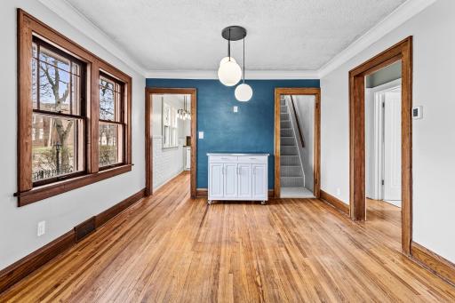 Dining room leads to kitchen to the left, upper level to the right and hallway to the bedrooms on the far right.jpg