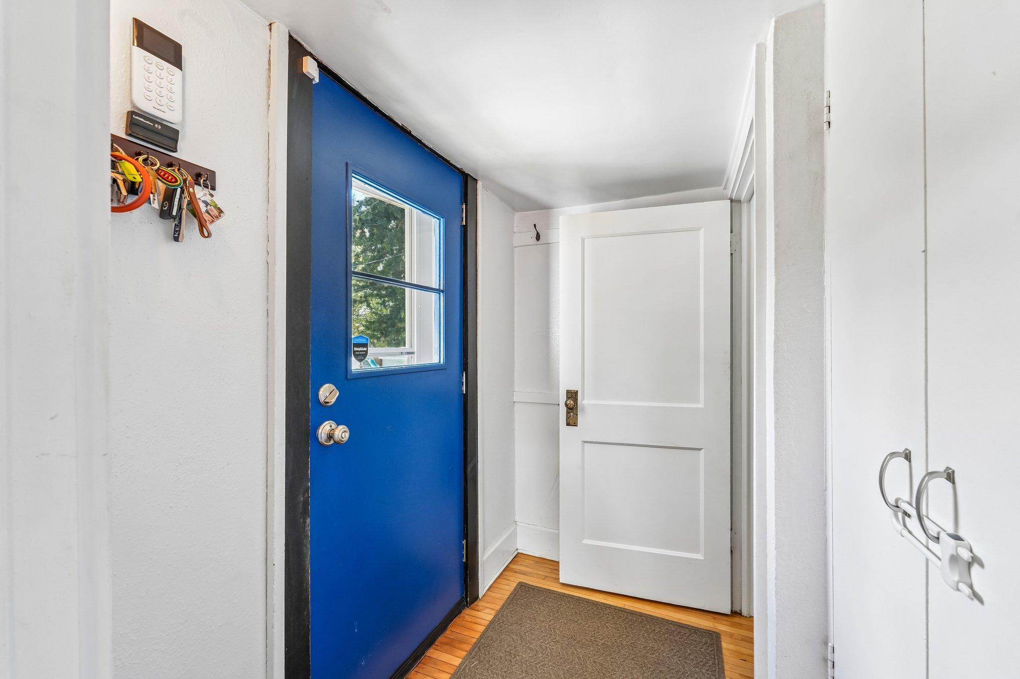 Backdoor leading to basement and kitchen