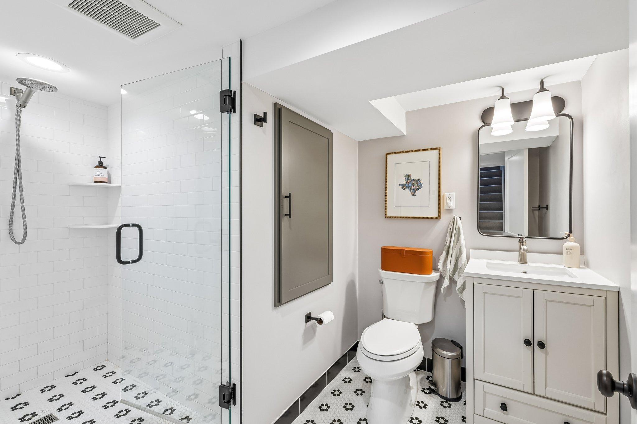 Basement bathroom w/tiled shower and flooring