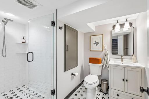 Basement bathroom w/tiled shower and flooring