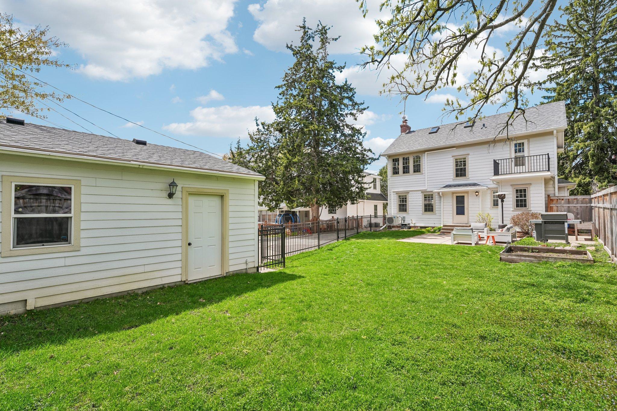 Large fully fenced in yard with 2 car garage