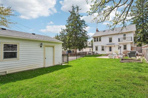 Large fully fenced in yard with 2 car garage