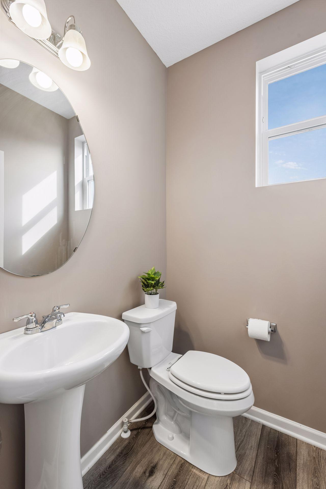 Main floor powder room is discreetly tucked away