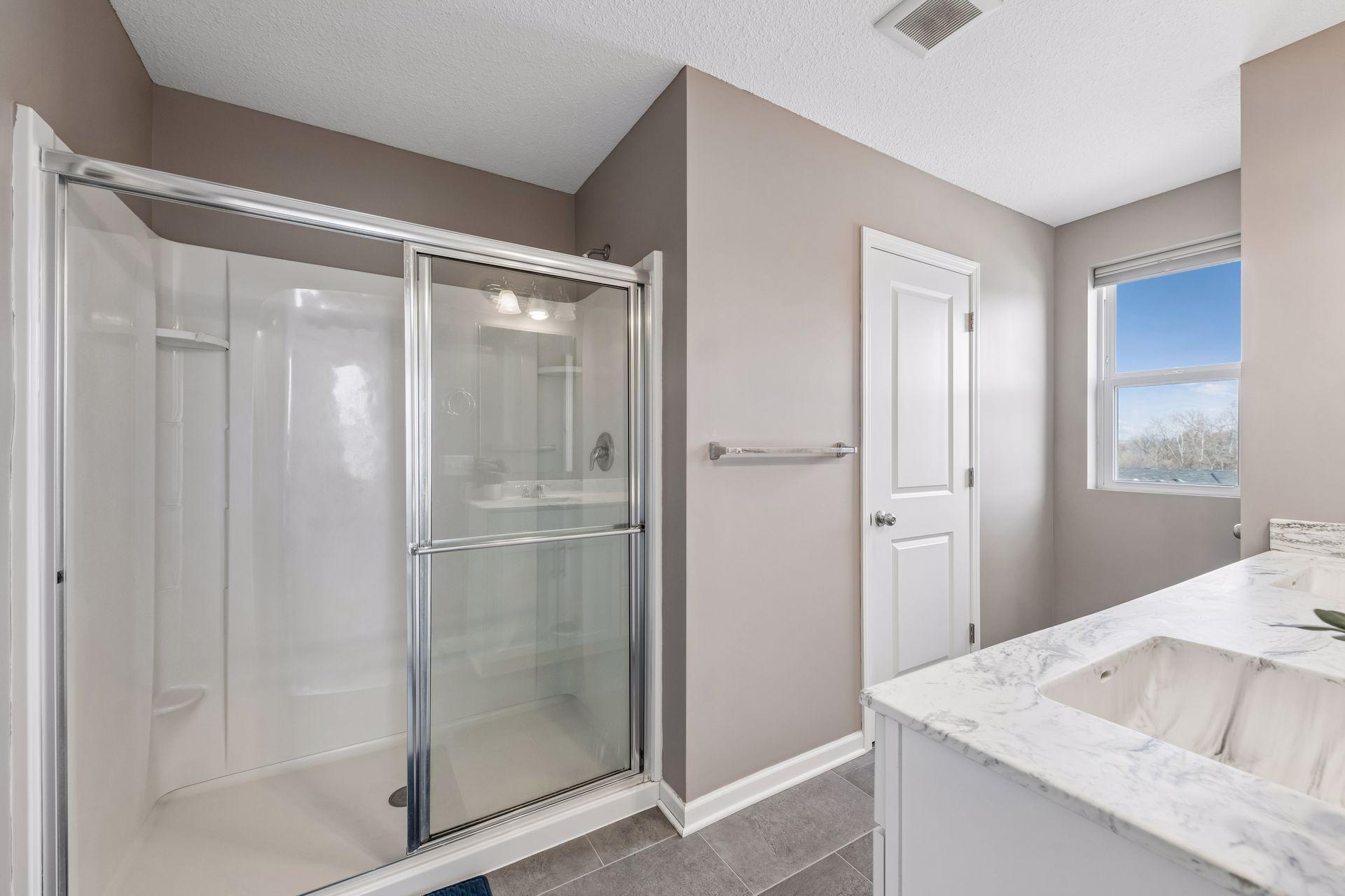 Private, primary bathroom with two sinks and stool room
