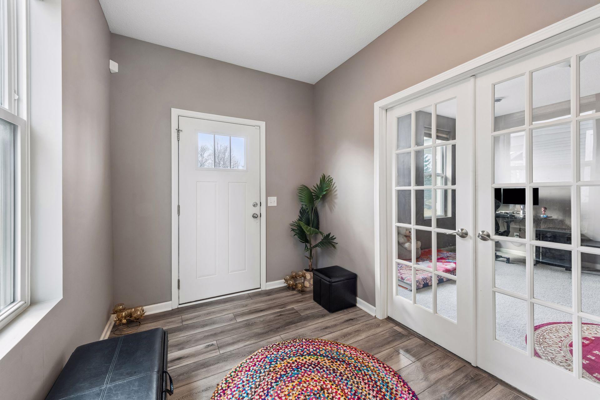 Glass-front French doors allow flex room to be closed off, if desired