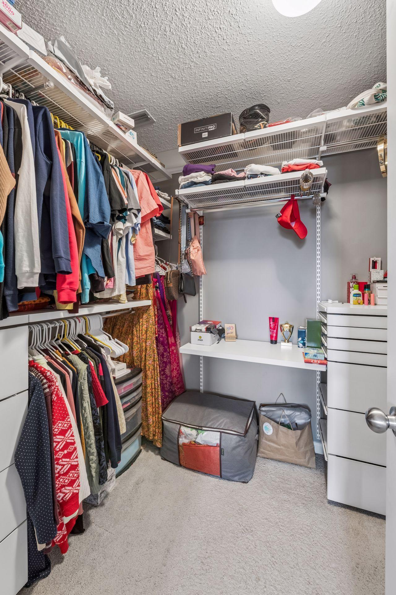 Primary bedroom walk-in closet with organization system