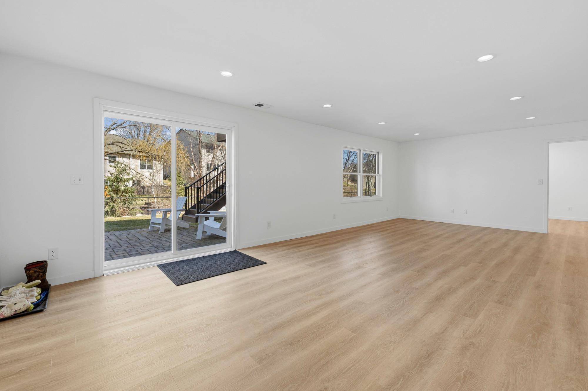 Newly finished walk out lower level with premium vinyl plank floors