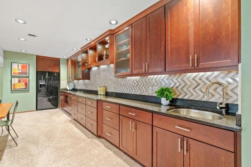 The highlight of this space is the stunning, full wall bar area