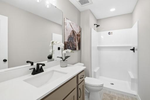 Lower level 3/4 bath offers a large vanity & sink.