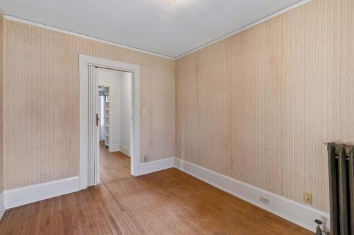 Another view of the first upper level bedroom, showing access to the hallway and flow of the upper level.