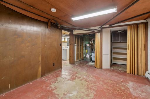 Versatile lower level storage room offering the chance to create your ideal workspace, media room, or bonus living space.