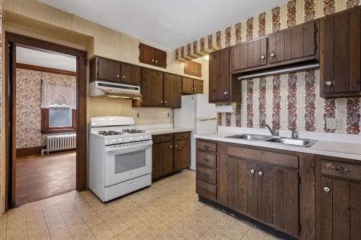 This kitchen features a double sink, new stove, and ample storage, fully usable today, with excellent potential for upgrades and customization.