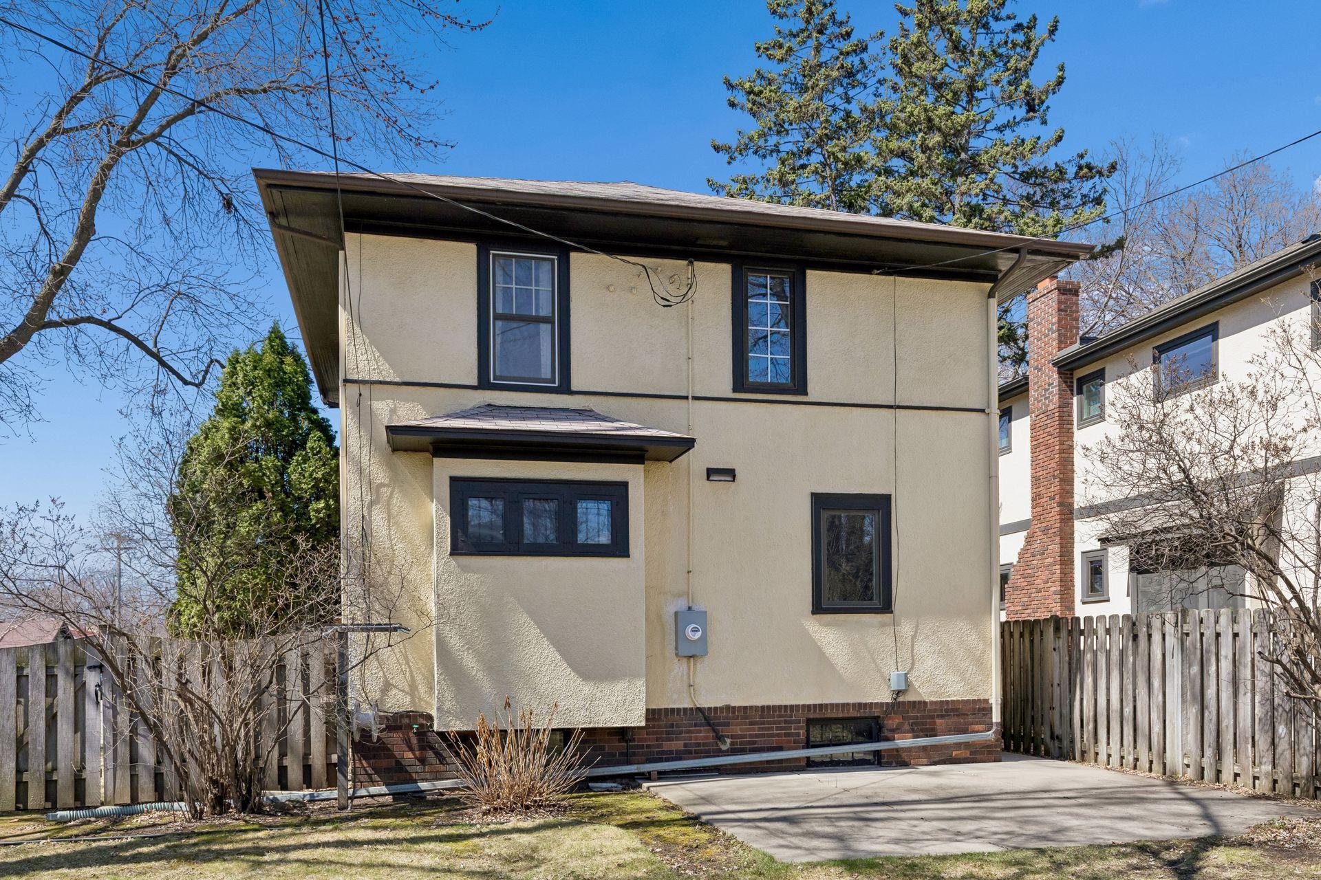 Classic stucco siding for this south Minneapolis home! Enjoy grilling and entertaining on the concrete patio!