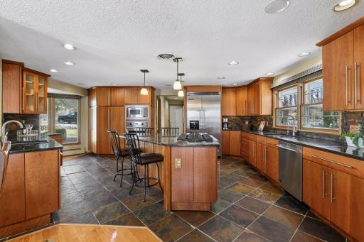 Kitchen features granite countertops, Viking appliances, and built in bar for entertainment.