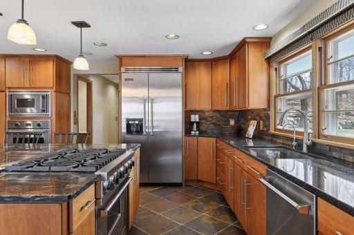 Kitchen featuring professional range, custom cabinetry, and granite counters make this kitchen perfect for entertaining.