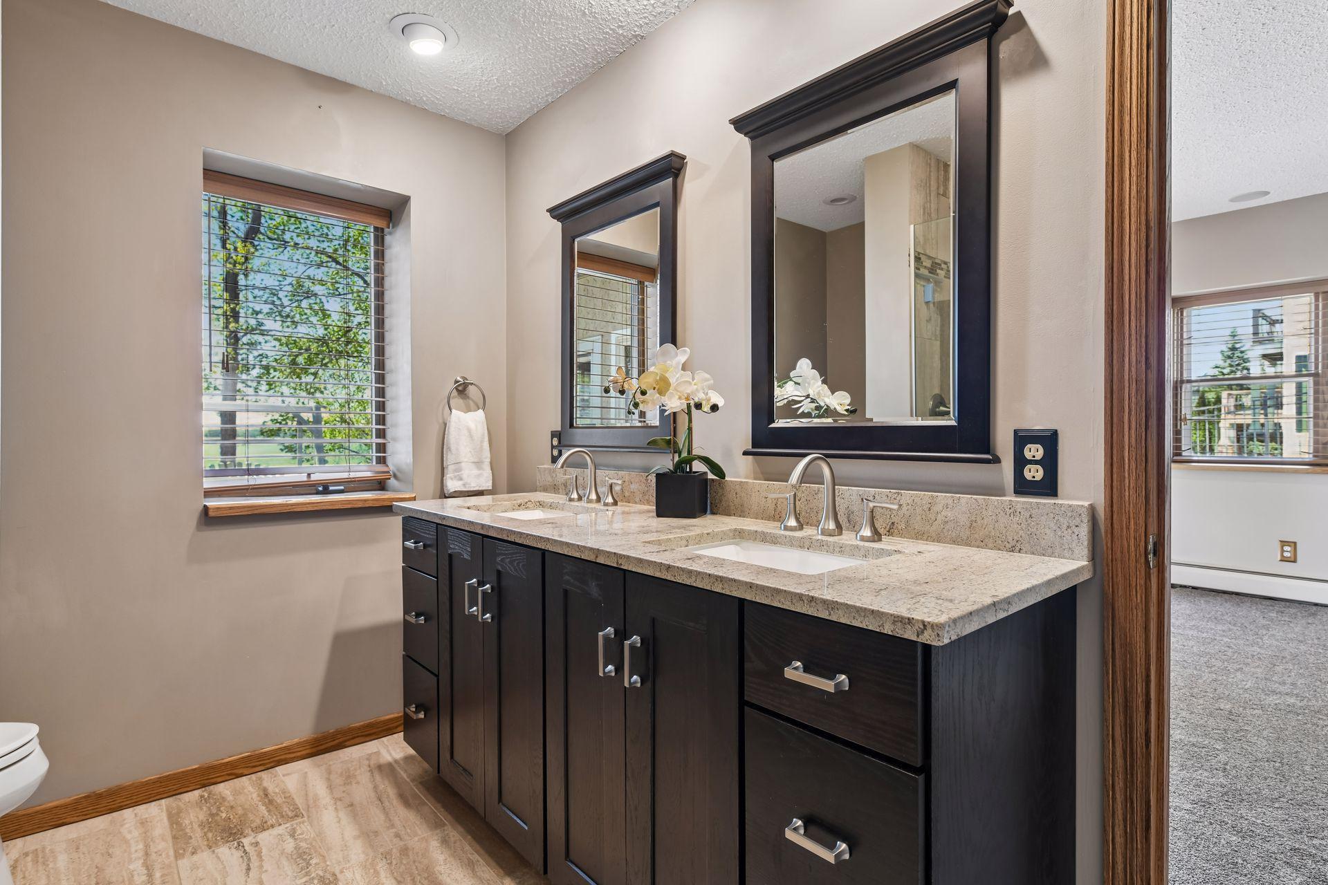 Dual vanity in the lower level bathroom with granite countertops.